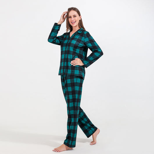 Family of four and dog wearing matching green and black plaid pajamas. Mother and father in two-piece sets, girl in dress, baby in two-piece, and dog in bandana - Image 5