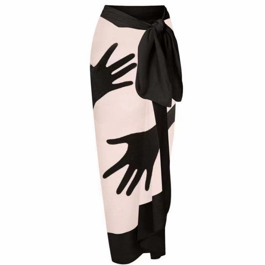 Women's light pink one-piece bikini with black handprint pattern and matching tie-waist sarong. - Image 5