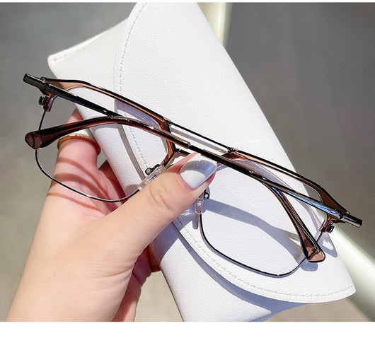 Anti-blue light glasses with a sand black and silver double beam frame, held against a white case. - Image 17