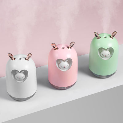 White rabbit humidifier with rose gold ears, a heart-shaped cutout, and a smiling bunny figure inside. - Image 7