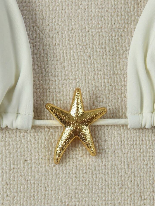 White women's bikini with triangle top and tie-side bottom, featuring a gold starfish charm on the center front. - Image 33
