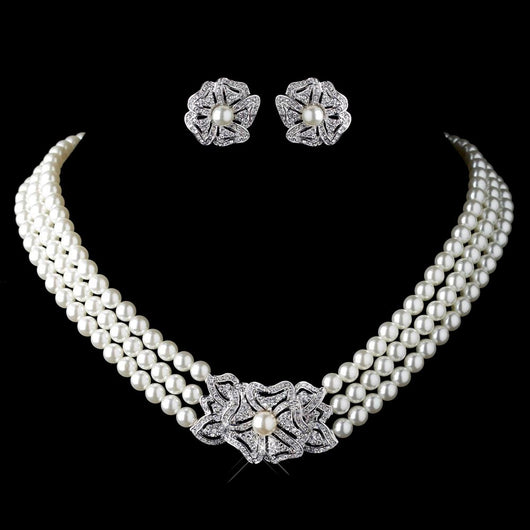 Three-strand pearl necklace with a rhinestone flower clasp and matching pearl and rhinestone flower stud earrings. - Image 3