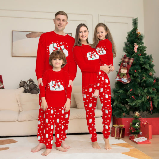 Family of four wearing matching red Christmas pajamas with polar bear and snowflake print, standing by a Christmas tree. - Image 10