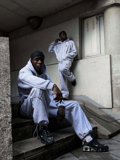 Light gray hooded tracksuit with dark gray contrast stitching, featuring a full-zip hoodie and matching loose sweatpants. - Image 9