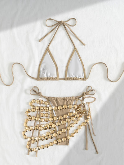 Copper halter bikini top and bottom with a gold beaded skirt, laid flat with sunglasses, seashell, and flowers. - Image 19