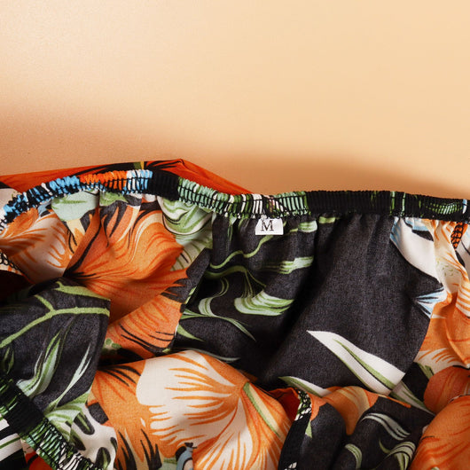 Family matching Hawaiian outfits: men's shirt and shorts, women's off-shoulder maxi dress, girl's dress, boy's shirt and shorts, all with black, orange hibiscus - Image 12