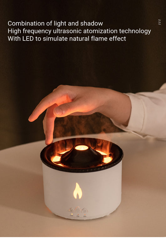 White ultrasonic essential oil diffuser with orange flame effect mist, alongside a gift set of Lavender, Peppermint, Tea Tree, and Sweet Orange essential oils. - Image 18