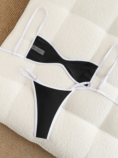 Black and white strapless bikini swimsuit set with adjustable straps and a ruched bottom, laid flat. - Image 14