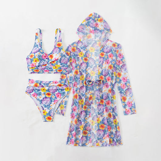 Woman in a red multicolor floral print three-piece swimsuit with high-waisted bikini and long-sleeve cover-up, straw hat, and sunglasses on a beach. - Image 24