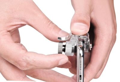 Pair of clear mobile game trigger buttons with silver levers and a clear plastic box on a dark textured surface. - Image 5
