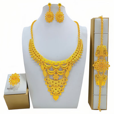 Gold-colored women's jewelry set with ornate floral and filigree designs, including a necklace, drop earrings, bracelet, and ring.