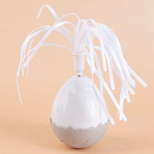Electronic cat motion toy, a white and grey tumbler ball with fluffy pom-pom and soft wings, next to its retail box. - Image 5