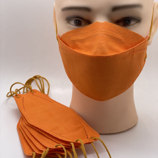 Blue fish-shaped disposable mask on a mannequin head, with more masks stacked in the foreground.