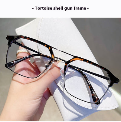 Anti-blue light glasses with a sand black and silver double beam frame, held against a white case. - Image 21