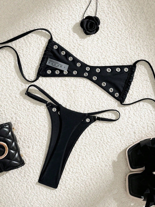Black bandeau bikini swimsuit with thin straps and a gold-toned abstract ring detail on the top, paired with matching string bottoms. - Image 41
