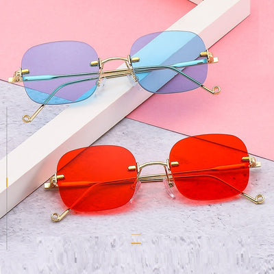 Frameless square sunglasses featuring vibrant blue lenses and sleek gold-colored metal temples and bridge.