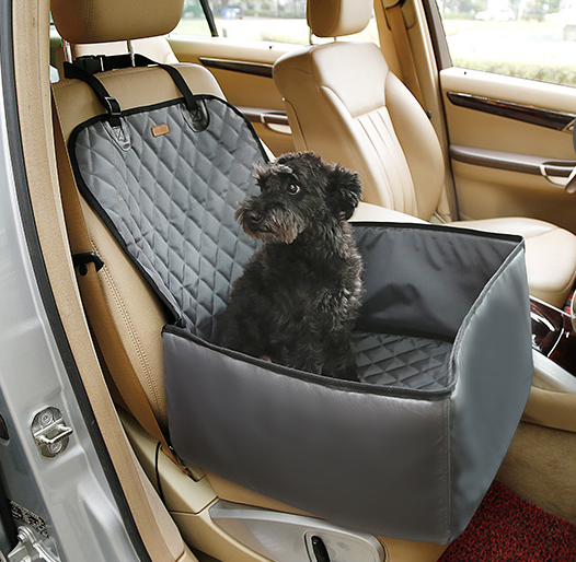Black quilted waterproof pet seat cover and booster pad installed in a beige car, with a black dog sitting on it.