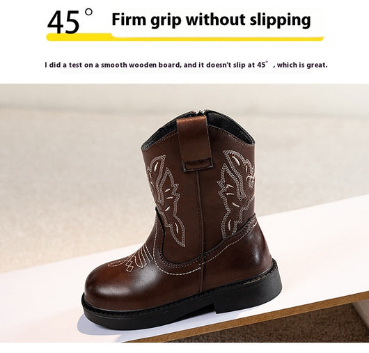 Girls' brown Martin boots with white ethnic embroidery, side zippers, and black soles, displayed on a light carpet. - Image 12