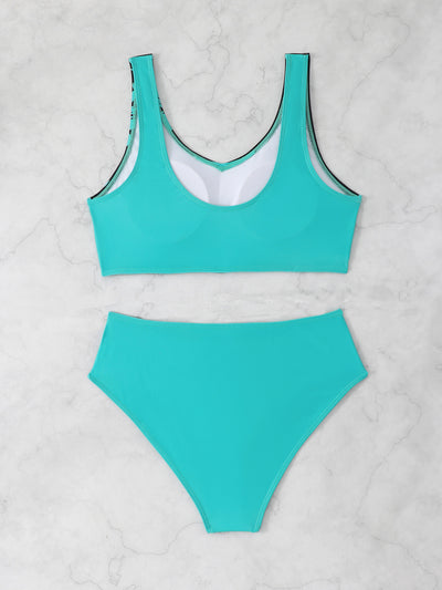 Women's two-piece swimsuit with black and purple floral print. Features a V-neck sports bra top and mid-rise bottom. - Image 12
