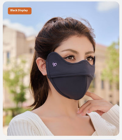 Woman wearing a grey outdoor cycling wind mask with ear hooks and a small heart logo, designed for cold-proof eye protection. - Image 12