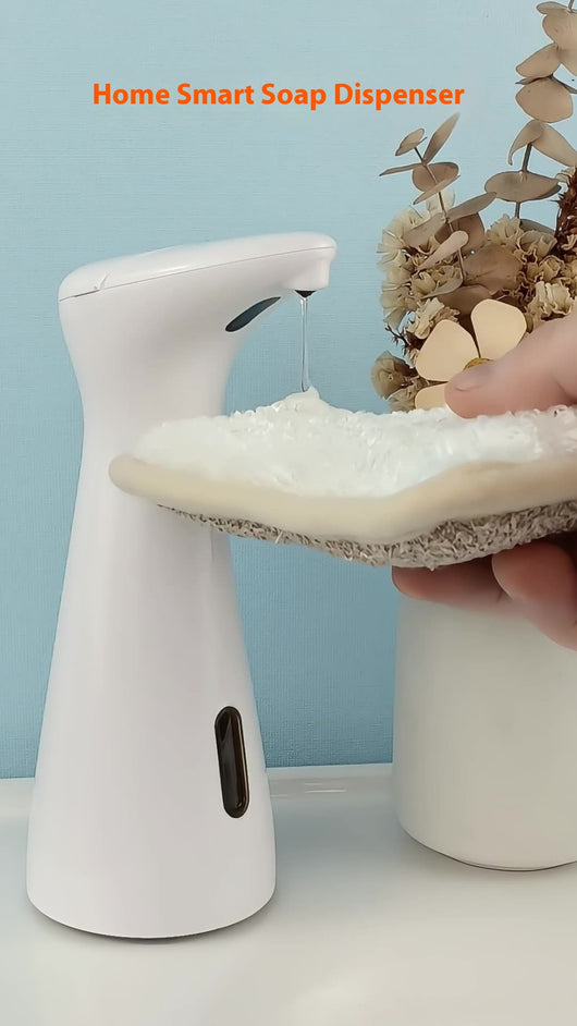 White automatic soap dispenser with an infrared sensor, dispensing blue liquid soap onto an outstretched hand. - Image 8
