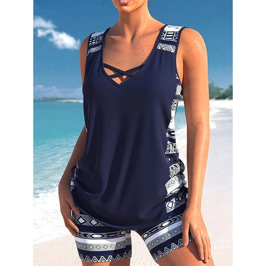 Women's navy blue tankini swimsuit with geometric pattern, criss-cross V-neck, and matching swim shorts. - Image 6