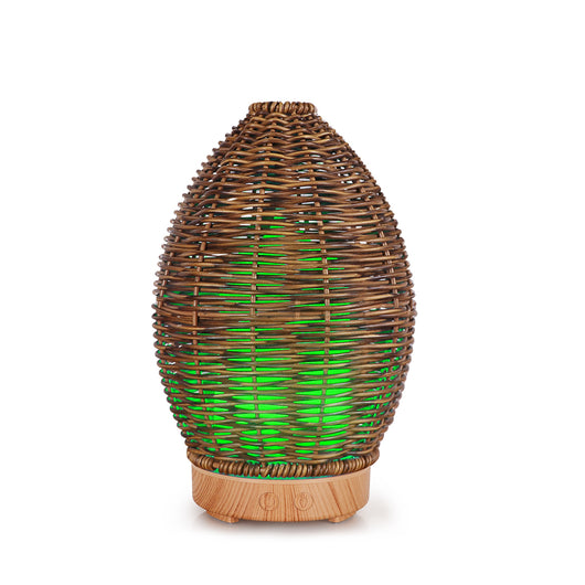 Hollow rattan aroma diffuser with an egg-shaped woven brown exterior and a light wood-grain base. - Image 10
