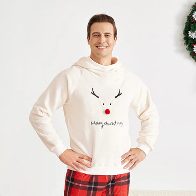 Family of four wearing matching cream fleece reindeer pajamas with red plaid pants, posing for a Christmas photo. - Image 18