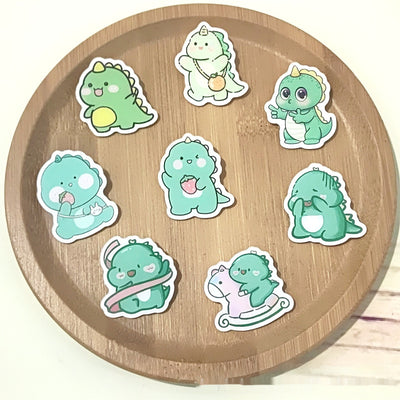 Cute green cartoon dinosaur acrylic badge brooch with a shy expression and small spikes on its back. - Image 3