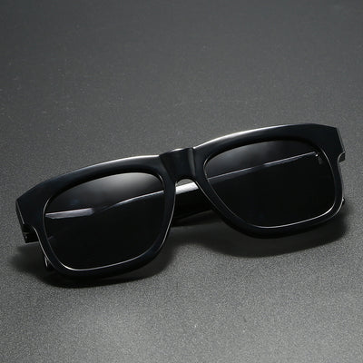 Black square-frame polarized sunglasses with dark lenses, suitable for both men and women, on a dark gray surface. - Image 9