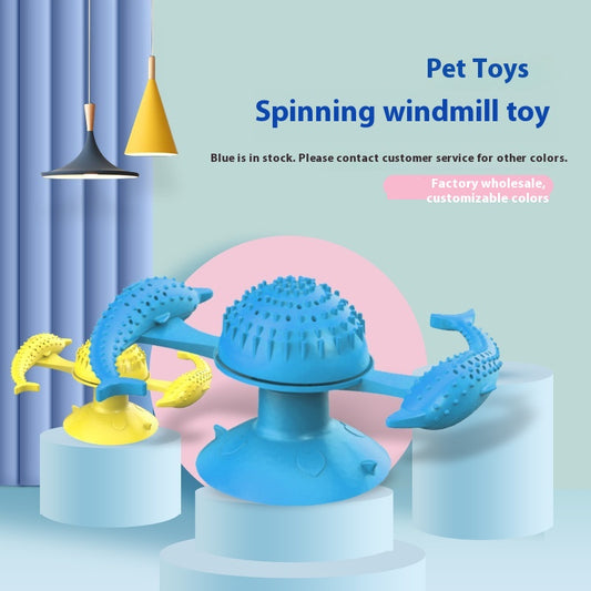 Blue pet toy for cats featuring a spinning windmill design with two dolphin-shaped arms and a suction cup base.