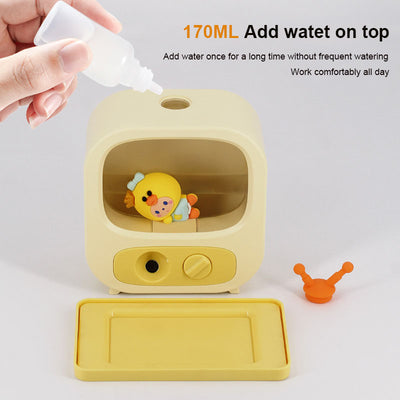 Pink TV-shaped desktop humidifier with a cute pink caterpillar figure inside, featuring a mist outlet and control knob. - Image 2