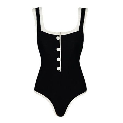 Woman in a white one-piece swimsuit with black trim and decorative buttons, sitting on a boat. - Image 5