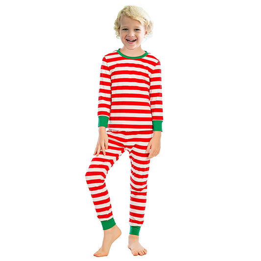 Girl wearing red and white striped long-sleeved pajamas with green trim on collar and cuffs. - Image 2