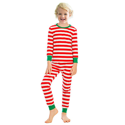 Girl wearing red and white striped long-sleeved pajamas with green trim on collar and cuffs. - Image 2