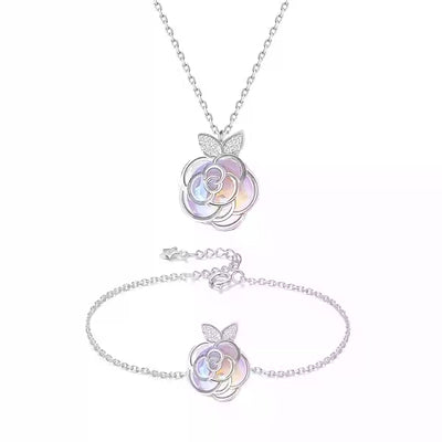 Gold-tone necklace with an iridescent camellia flower pendant and small clear stones on a delicate chain. - Image 10
