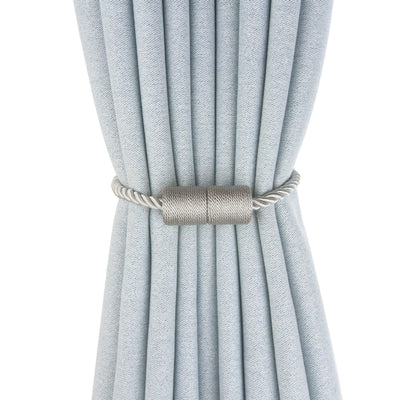 Black cylindrical magnetic curtain tieback holding a light blue pleated curtain, against a clean white background. - Image 2
