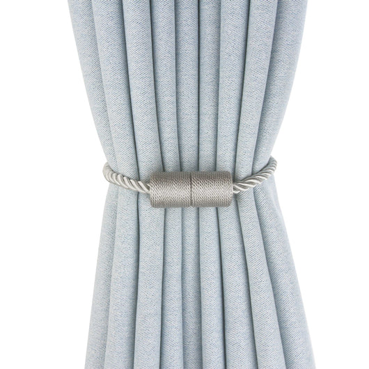 Black cylindrical magnetic curtain tieback holding a light blue pleated curtain, against a clean white background. - Image 2