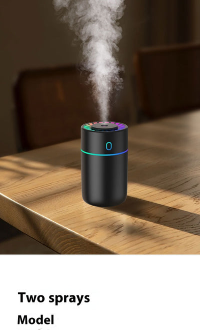 Pink cylindrical humidifier with a colorful LED light ring on top and a blue-green light band around its middle. - Image 10