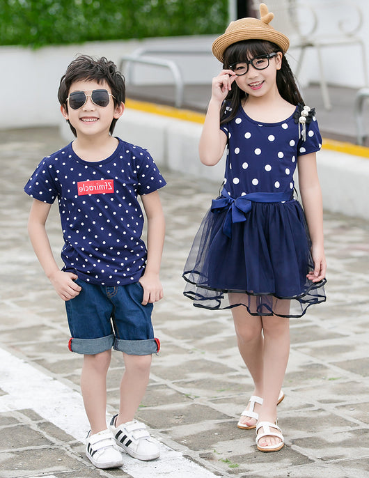 Family of four wearing matching white and black polka dot outfits. Dad and son in t-shirts, mom and daughter in dresses. - Image 10