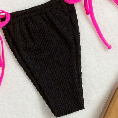 Black textured two-piece bikini with hot pink lace-up ties. Features a halter triangle top and high-cut bottoms. - Image 5