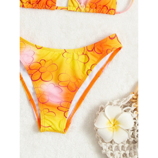 Yellow and orange floral string bikini swimsuit for women, featuring a triangle top and high-cut bottoms by a pool. - Image 5