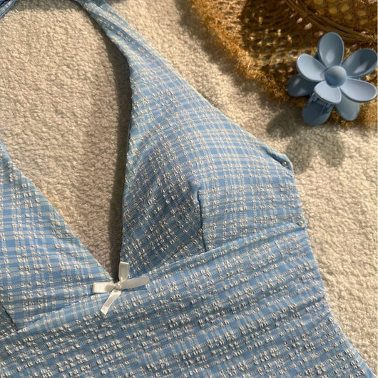 Light blue textured plaid two-piece swimsuit with a halter top and side-tie bikini bottoms, featuring small white bows. - Image 3