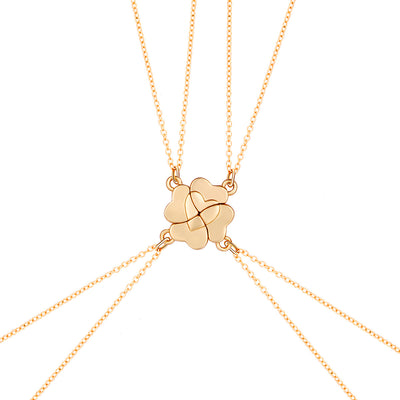 Four silver-colored necklaces, each with a half-heart charm that forms a four-leaf clover when combined, on pink satin. - Image 7