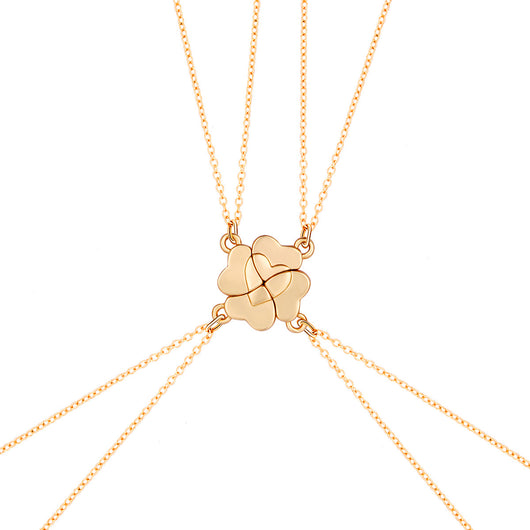 Four silver-colored necklaces, each with a half-heart charm that forms a four-leaf clover when combined, on pink satin. - Image 7