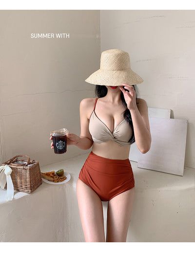 Woman in a blue twisted triangle bikini top and white high-waisted bottoms, holding a leaf-print cover-up. - Image 14