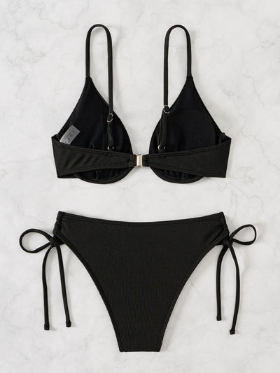 Black ribbed two-piece bikini with an underwire top and tie-side bottoms on a white marble surface. - Image 22
