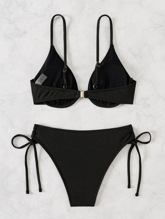 Black ribbed two-piece bikini with an underwire top and tie-side bottoms on a white marble surface. - Image 22