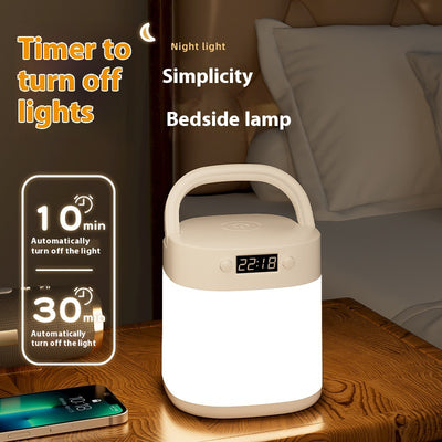 White rechargeable LED table lamp with a digital clock display and a light gray carrying handle.