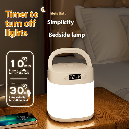 White rechargeable LED table lamp with a digital clock display and a light gray carrying handle.